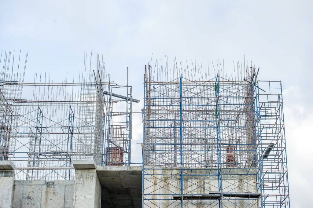 Image of a part-built building with foundations and scaffolding. 