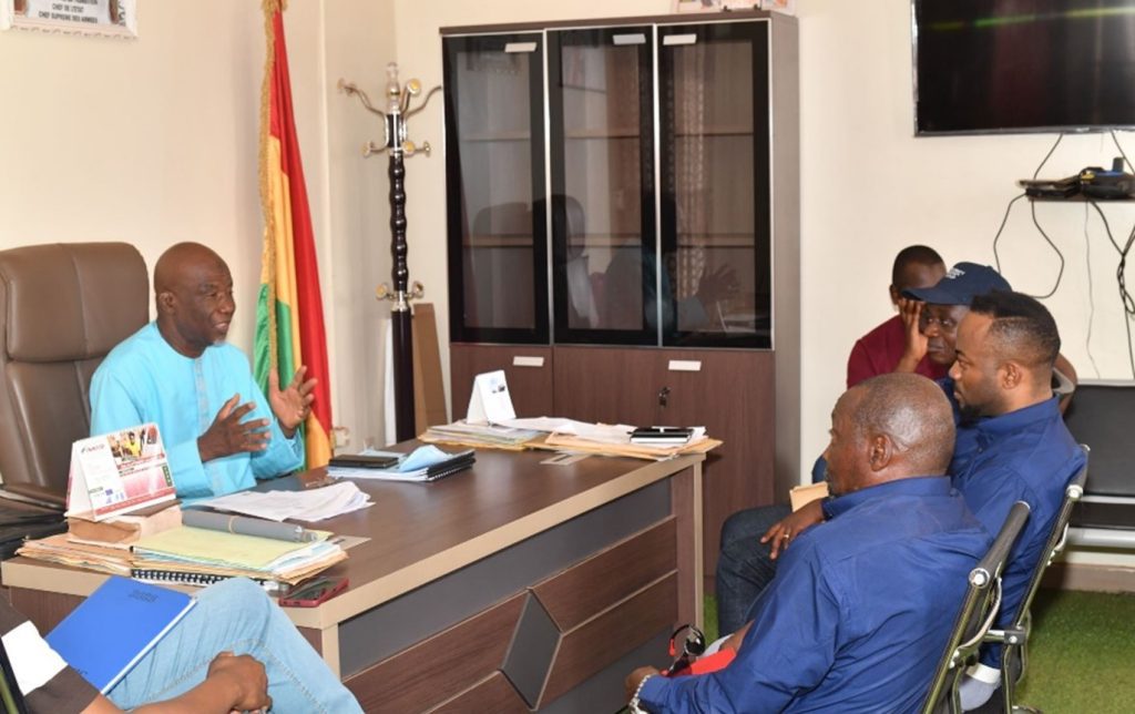 A picture of Seventy Ninth Resources at a meeting with an official in his office in Guinea 