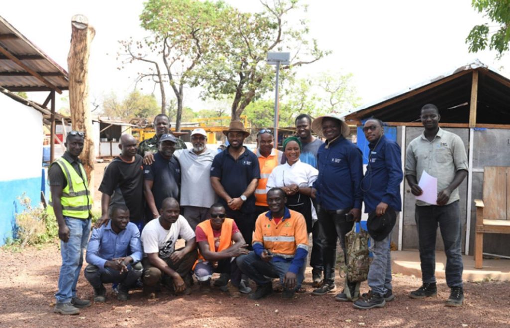 Image of Eric Ntube, In-Country Manager at Seventy Ninth Resources with a group of local people and Seventy Ninth workers in Guinea 