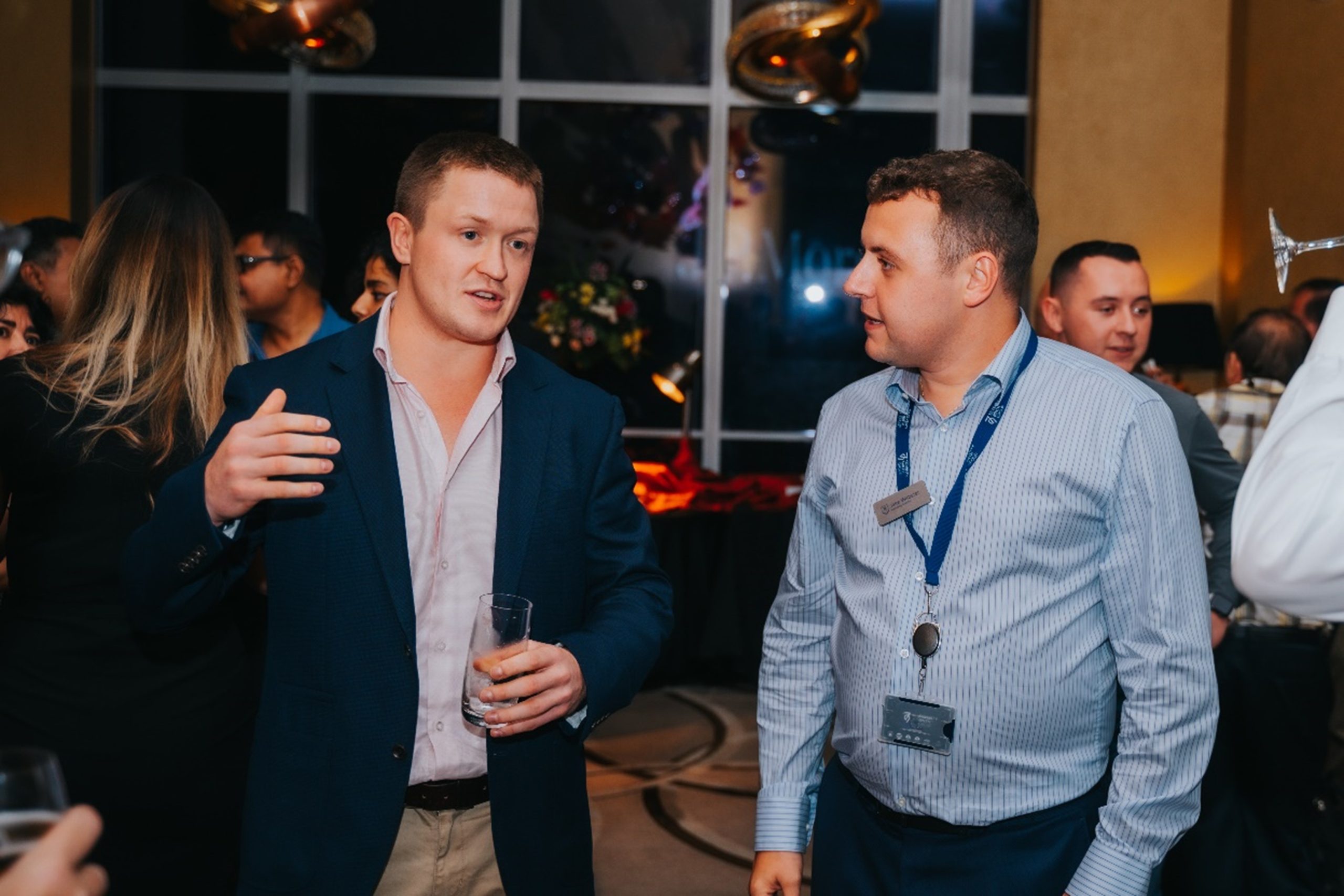 A picture of two genetlement at a corporate event